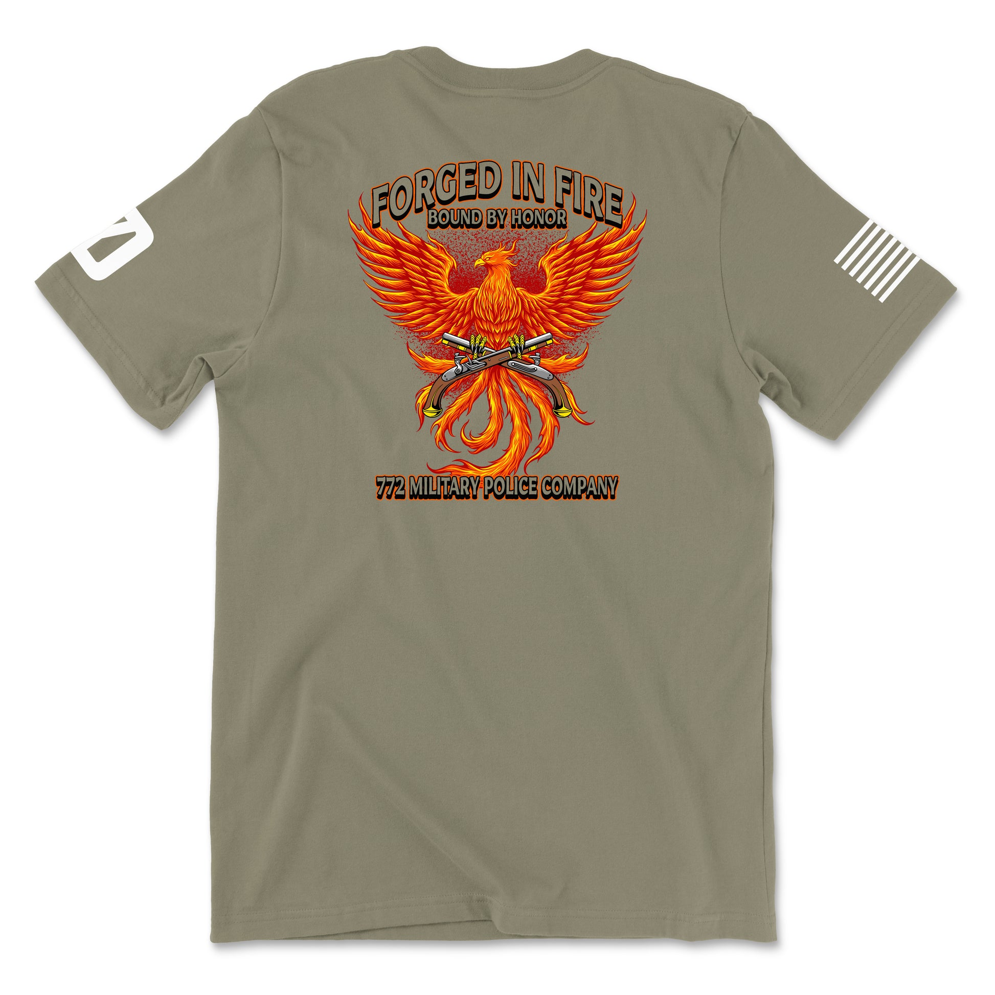 Back view of a coyote brown t-shirt for the 772nd Military Police Company. The design features a large orange and yellow phoenix rising from flames, with crossed flintlock pistols and a blue infantry disc at its center. Banners above read 'FORGED IN FIRE' and 'BOUND BY HONOR,' with '772 MILITARY POLICE COMPANY' written in red at the bottom. A white American flag patch is on the right sleeve.