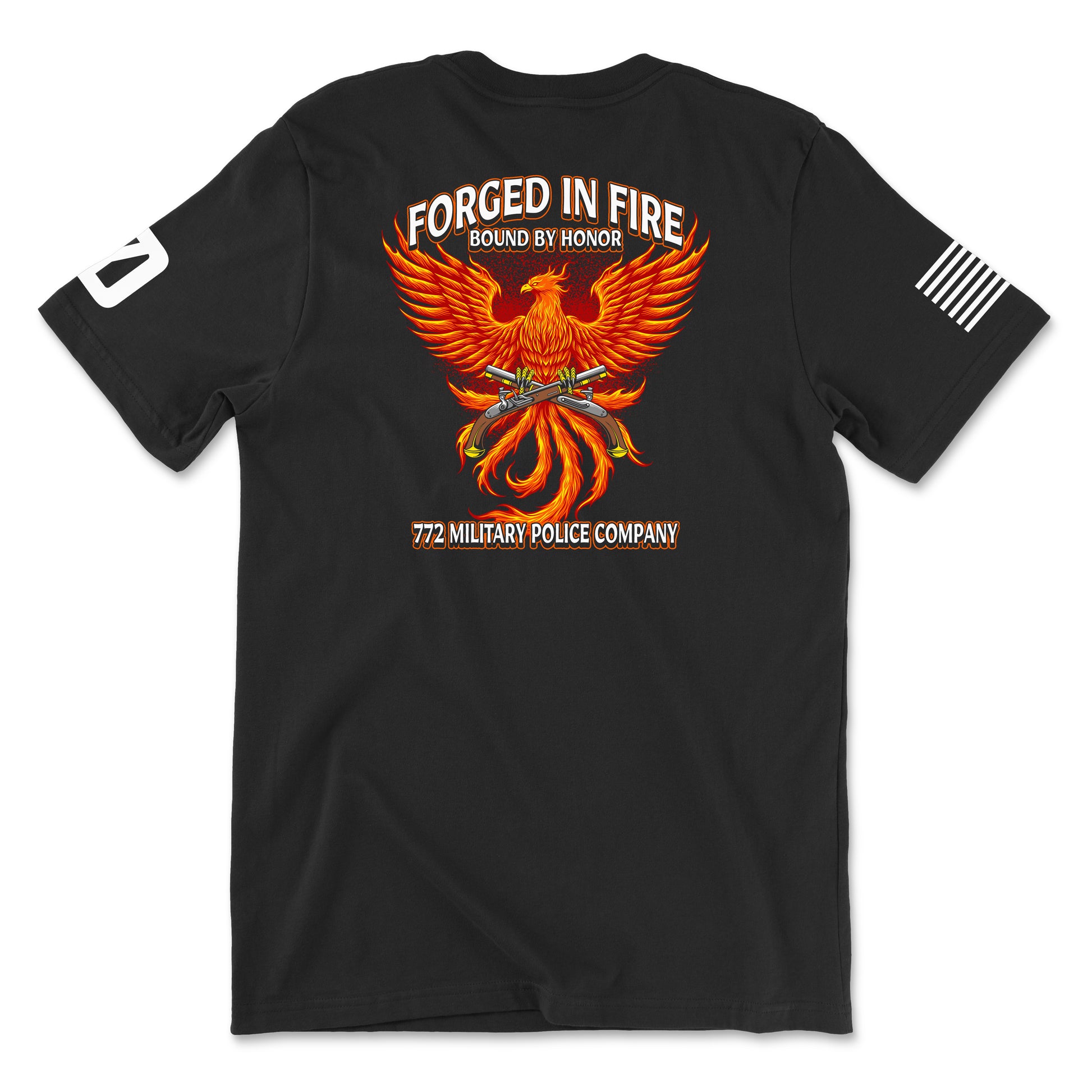 Back view of a black t-shirt for the 772nd Military Police Company. The design features a large orange and yellow phoenix rising from flames, with crossed flintlock pistols and a blue infantry disc at its center. Banners above read 'FORGED IN FIRE' and 'BOUND BY HONOR,' with '772 MILITARY POLICE COMPANY' written in red at the bottom. A white American flag patch is on the right sleeve.