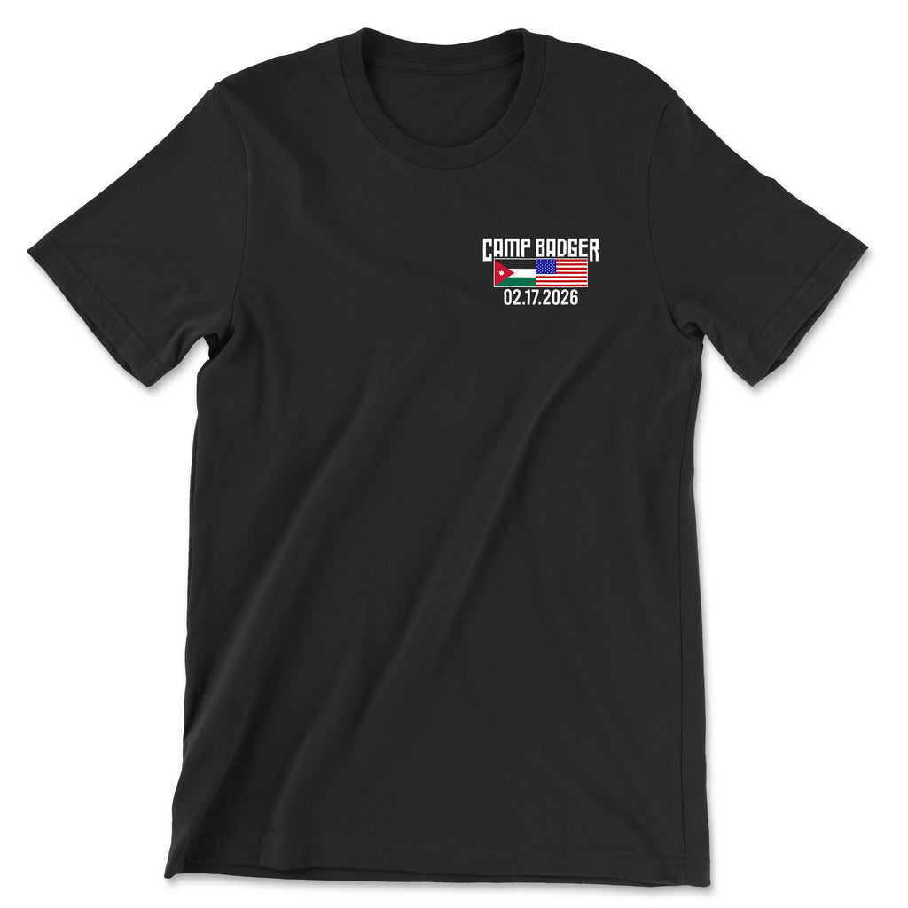 Front view of a black t-shirt for the Camp Badger Lunar New Year 5K. The left chest features a small graphic with the text 'CAMP BADGER' above the date '02.17.2026.' The design includes the national flags of Jordan and the United States side-by-side.