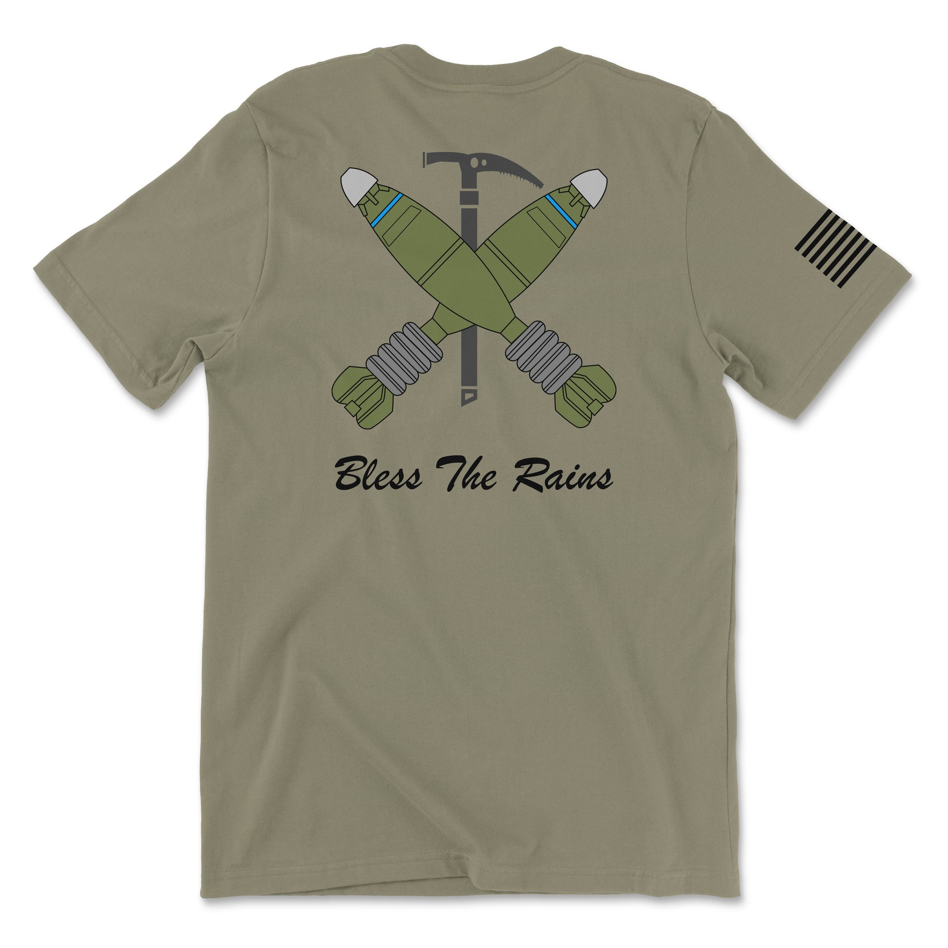 Back view of a coyote brown t-shirt featuring a tactical graphic. The design shows two green mortar shells crossed over a black ice axe. Below the graphic, the text 'Bless The Rains' is written in white cursive script. A white American flag patch is visible on the right sleeve